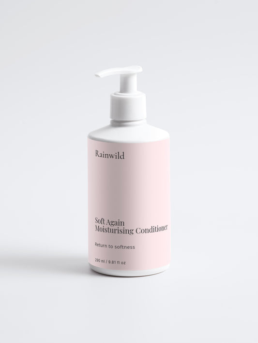 Pink bottle of Rainwild Soft Again Moisturising Conditioner on a light gray background